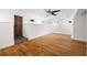 Bright living room with hardwood floors, a ceiling fan, and natural light from multiple windows, and a wooden door at 272 14Th St # 23, Atlanta, GA 30309