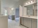 Bathroom with double vanity, framed mirrors, and open doorway to bedroom at 2780 Dolce Rd, Dacula, GA 30019