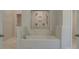 Bathroom with a soaking tub, marble surround, and dual shower heads at 2780 Dolce Rd, Dacula, GA 30019