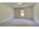 A serene bedroom with neutral carpet, and a single window offering natural light at 2780 Dolce Rd, Dacula, GA 30019
