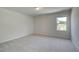 A bright bedroom with neutral carpet and a window offering natural light at 2780 Dolce Rd, Dacula, GA 30019