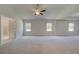 Spacious bedroom with trey ceiling, ceiling fan, and neutral carpet at 2780 Dolce Rd, Dacula, GA 30019
