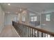 Bright upstairs hallway showcases an attractive railing and views into other rooms and downstairs at 2780 Dolce Rd, Dacula, GA 30019