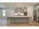 Modern kitchen with gray cabinets, stainless steel appliances, and a large island with pendant lighting at 2780 Dolce Rd, Dacula, GA 30019