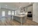 Stylish kitchen featuring a central island, stainless steel appliances and an open layout to the living area at 2780 Dolce Rd, Dacula, GA 30019