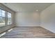 Bright and airy living room with wood-look floors and large windows at 2780 Dolce Rd, Dacula, GA 30019