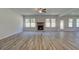 Spacious living room with wood-look floors, fireplace, and ample natural light at 2780 Dolce Rd, Dacula, GA 30019