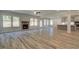 Open-concept living room with wood-look floors, fireplace, and views to the kitchen at 2780 Dolce Rd, Dacula, GA 30019