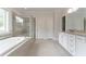 Well-lit bathroom with a bathtub and glass enclosed shower at 2910 Hampton Grove Trce, Dacula, GA 30019