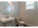 Modern half bathroom featuring a pedestal sink and window at 2910 Hampton Grove Trce, Dacula, GA 30019