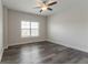 Bedroom featuring hardwood floors, a ceiling fan, and a large window at 2910 Hampton Grove Trce, Dacula, GA 30019
