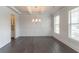 Elegant dining room with dark hardwood floors, decorative wainscoting, and a coffered ceiling at 2910 Hampton Grove Trce, Dacula, GA 30019