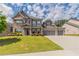 Beautiful two-story home with stone accents, three-car garage, and well-manicured lawn at 2910 Hampton Grove Trce, Dacula, GA 30019