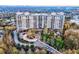Aerial view of residential tower surrounded by trees, with circular driveway and landscaped grounds at 2950 Mount Wilkinson Se Pkwy # 505, Atlanta, GA 30339