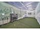 Indoor golf simulator room with netting and artificial turf for practicing your swing at 2950 Mount Wilkinson Se Pkwy # 505, Atlanta, GA 30339