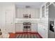 Stylish kitchen featuring stainless steel appliances, white cabinetry, and tiled backsplash at 2950 Mount Wilkinson Se Pkwy # 505, Atlanta, GA 30339