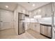 Well-lit kitchen featuring stainless steel appliances, white cabinetry, and tile flooring at 2950 Mount Wilkinson Se Pkwy # 505, Atlanta, GA 30339
