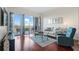 Bright living room features hardwood floors, comfortable seating, and access to a balcony at 2950 Mount Wilkinson Se Pkwy # 505, Atlanta, GA 30339