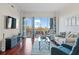 Bright living room featuring hardwood floors, a balcony, and views of the surrounding area at 2950 Mount Wilkinson Se Pkwy # 505, Atlanta, GA 30339
