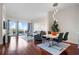 Open living space with hardwood floors, dining area, and leads to outdoor balcony at 2950 Mount Wilkinson Se Pkwy # 505, Atlanta, GA 30339