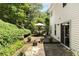 White home featuring a backyard with outdoor seating on the deck and stone patio at 5404 Trumpet Vine Se Trl, Mableton, GA 30126