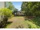 A spacious, grassy backyard features mature trees and a wooden fence, offering privacy and a serene outdoor space at 5404 Trumpet Vine Se Trl, Mableton, GA 30126