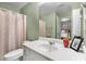 Green bathroom featuring white cabinetry and tub/shower with a neutral-toned shower curtain at 5404 Trumpet Vine Se Trl, Mableton, GA 30126