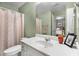 Bathroom with a shower/tub combo and white vanity with sage colored walls at 5404 Trumpet Vine Se Trl, Mableton, GA 30126