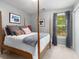 Bedroom featuring a four-poster bed, neutral walls, window with curtains and closet with white doors at 5404 Trumpet Vine Se Trl, Mableton, GA 30126