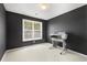 Bedroom featuring dark painted walls, carpeted floors, and a printer at 5404 Trumpet Vine Se Trl, Mableton, GA 30126