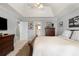 Bedroom featuring a tray ceiling, neutral tones, classic furnishings and easy access to the ensuite at 5404 Trumpet Vine Se Trl, Mableton, GA 30126