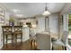 Bright dining area with a table for four, seamlessly connected to the kitchen with stainless steel appliances at 5404 Trumpet Vine Se Trl, Mableton, GA 30126