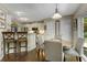 Bright dining area with hardwood floors connecting to the kitchen, perfect for casual meals and gatherings at 5404 Trumpet Vine Se Trl, Mableton, GA 30126