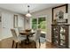 Cozy dining area featuring hardwood floors, a stylish cabinet, and access to the backyard at 5404 Trumpet Vine Se Trl, Mableton, GA 30126