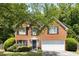 Charming two-story brick home with well-manicured landscaping and a two-car garage in a desirable neighborhood at 5404 Trumpet Vine Se Trl, Mableton, GA 30126