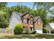 Side view of a two-story brick home with black shutters and a manicured lawn at 5404 Trumpet Vine Se Trl, Mableton, GA 30126