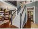 Open foyer with wood floors, staircase, and views to the office showcasing the home's design at 5404 Trumpet Vine Se Trl, Mableton, GA 30126