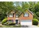 Charming two-story brick home featuring a well-maintained front yard and a two-car garage at 5404 Trumpet Vine Se Trl, Mableton, GA 30126