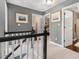 Upstairs hallway with gray walls, black and white banister, and open doorways to other rooms at 5404 Trumpet Vine Se Trl, Mableton, GA 30126