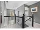 Upstairs hallway showcasing neutral colors, stair railing, an arched window, and an open layout at 5404 Trumpet Vine Se Trl, Mableton, GA 30126