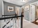 Upstairs hallway showcasing neutral tones, a stair railing and doorways to bedrooms and bath at 5404 Trumpet Vine Se Trl, Mableton, GA 30126