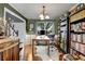 The home office has a large desk, bookshelves, and wainscoting at 5404 Trumpet Vine Se Trl, Mableton, GA 30126