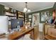 The home office has built-in bookshelves, a large desk, and warm lighting at 5404 Trumpet Vine Se Trl, Mableton, GA 30126