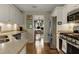 This kitchen has stainless steel appliances, granite countertops, and white cabinets at 5404 Trumpet Vine Se Trl, Mableton, GA 30126