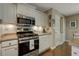 Modern kitchen featuring stainless steel appliances, white cabinets, and lots of counter space at 5404 Trumpet Vine Se Trl, Mableton, GA 30126