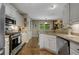 Well-maintained kitchen has white cabinets, stainless steel appliances, and granite countertops at 5404 Trumpet Vine Se Trl, Mableton, GA 30126
