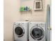 Laundry room featuring a side-by-side washer and dryer and a shelf with various cleaning supplies at 5404 Trumpet Vine Se Trl, Mableton, GA 30126