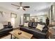 Comfortable living room showcasing hardwood floors, ceiling fan, and an open view of the adjacent kitchen at 5404 Trumpet Vine Se Trl, Mableton, GA 30126