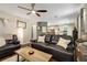 Inviting living room with hardwood floors, comfortable seating, ceiling fan, and seamless flow to the kitchen at 5404 Trumpet Vine Se Trl, Mableton, GA 30126