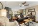 Open-concept living room with ceiling fan, hardwood floors, and seamlessly connected dining area at 5404 Trumpet Vine Se Trl, Mableton, GA 30126